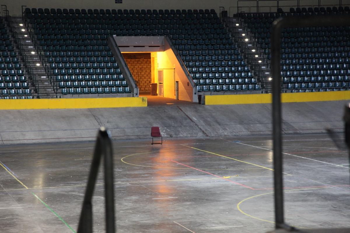 Velodrome infield floor with court markings and seating banks behind
