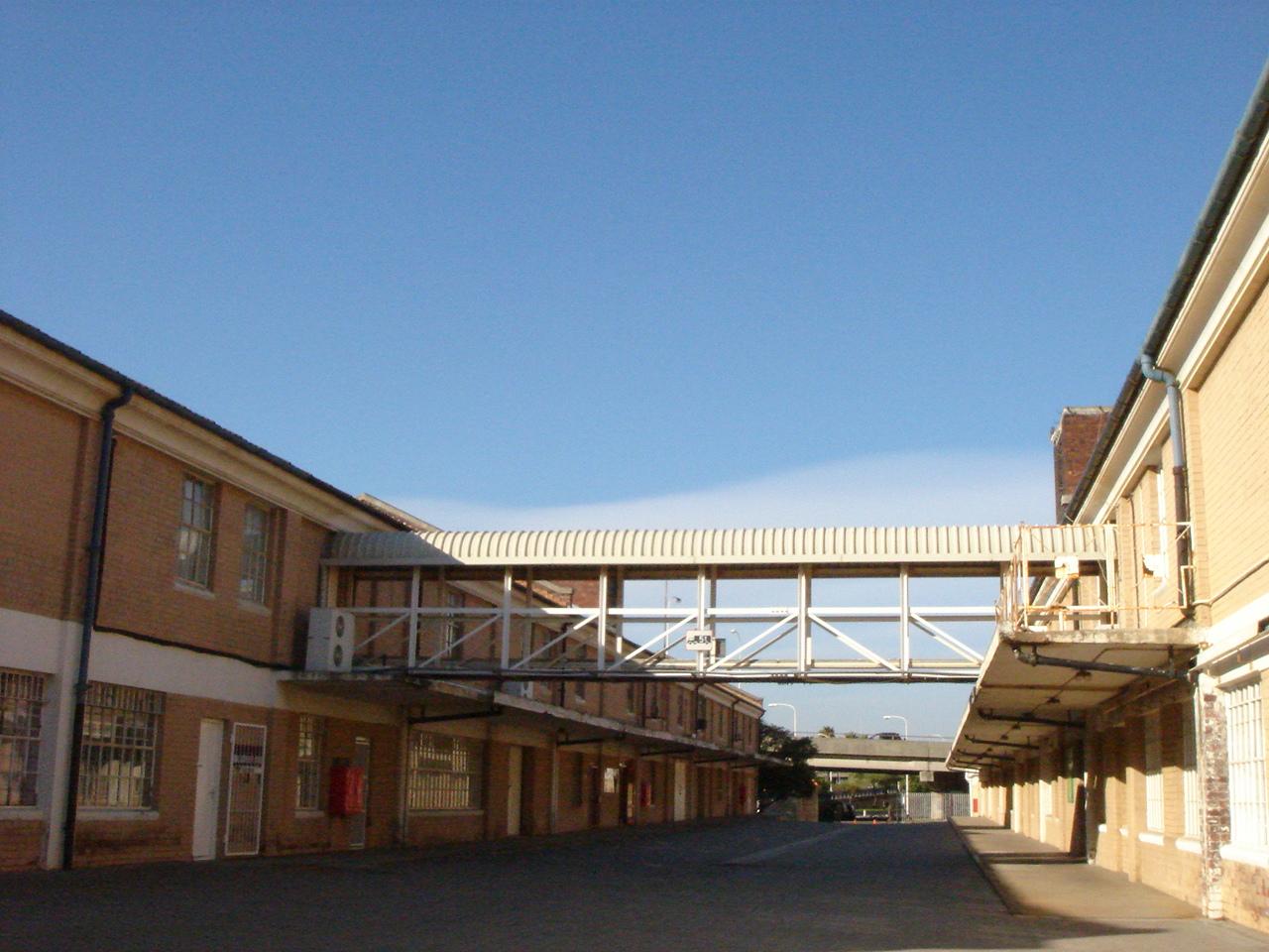Long internal service street with a bridge linking upper floors