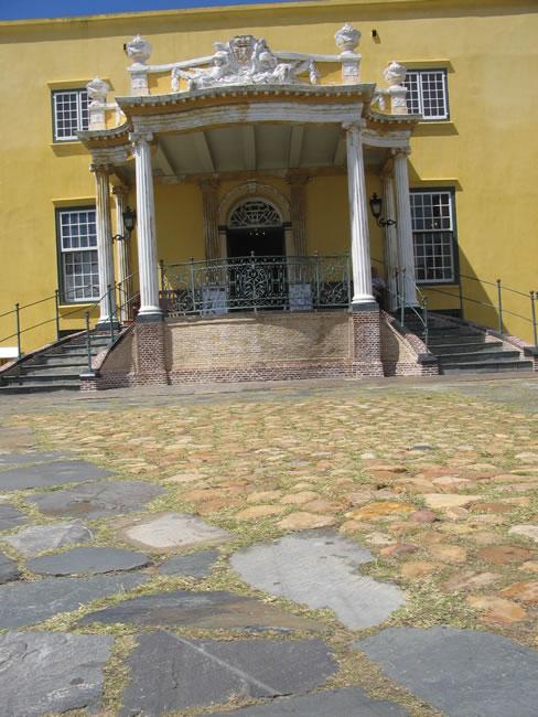 The sculpted Kat Balcony of the Castle of Good Hope above a cobbled courtyard