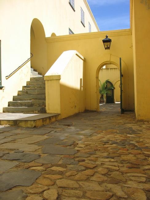 Ochre stair and archway with lantern inside the castle walls