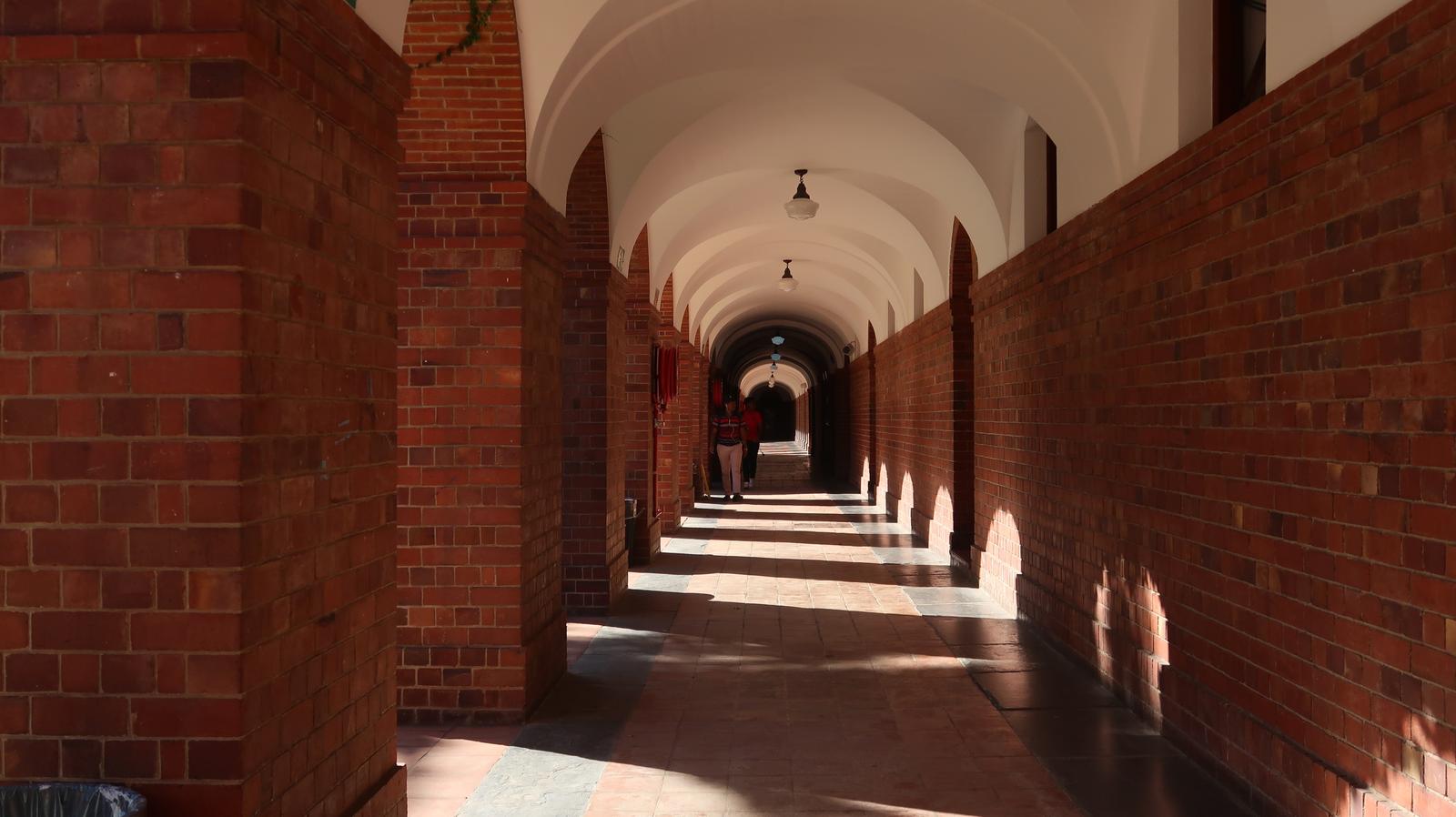 Brick arcade corridor with arches receding at Smuts Hall